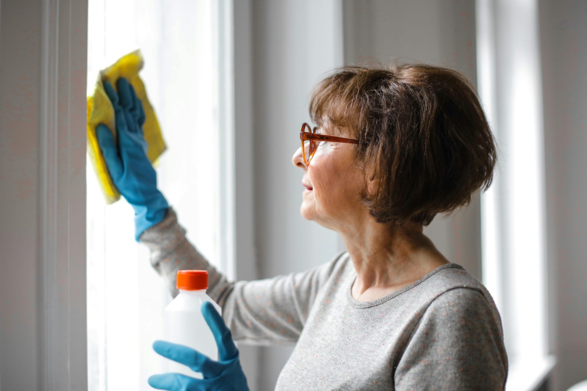 Man cleaning window with spray