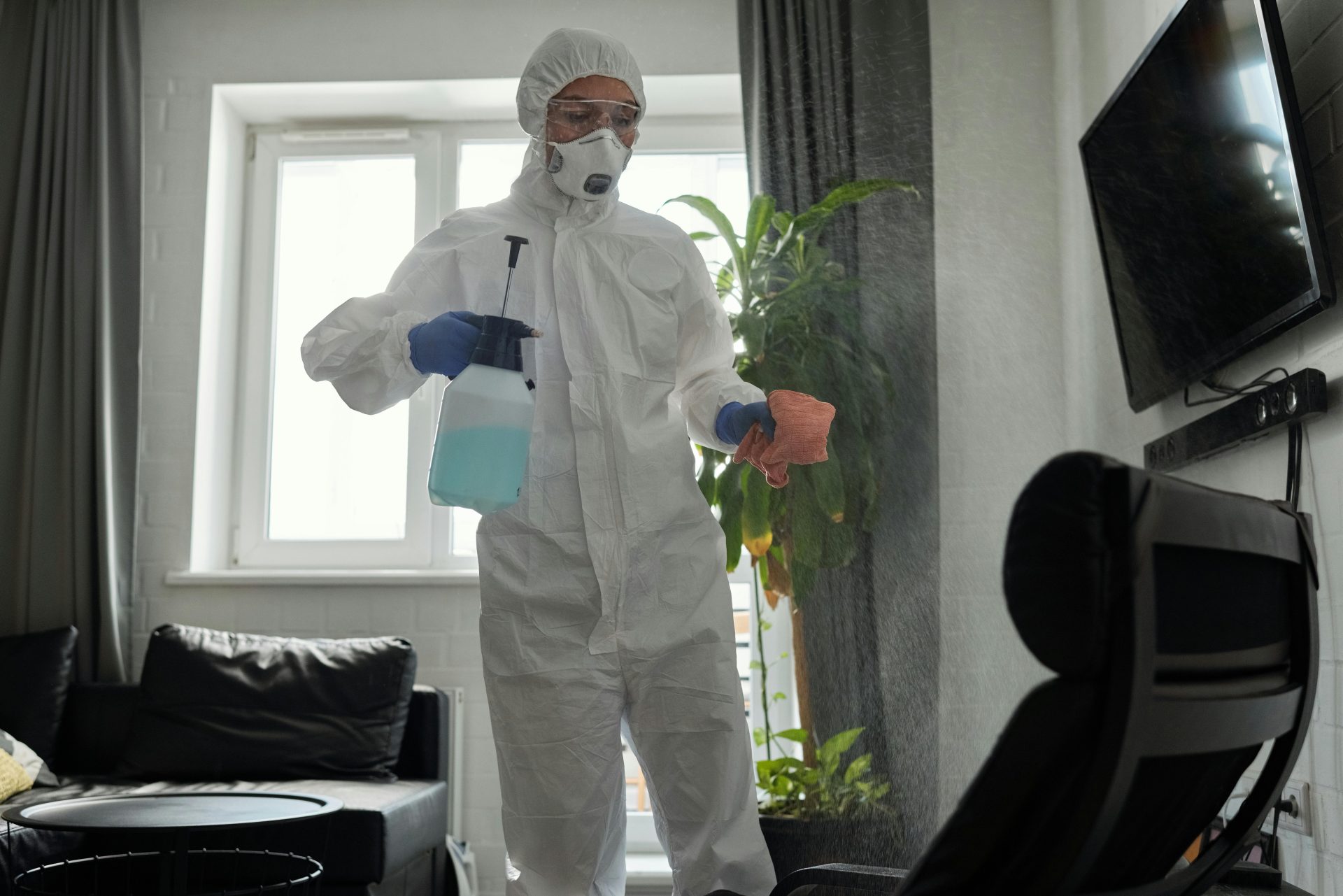 Man cleaning window with spray
