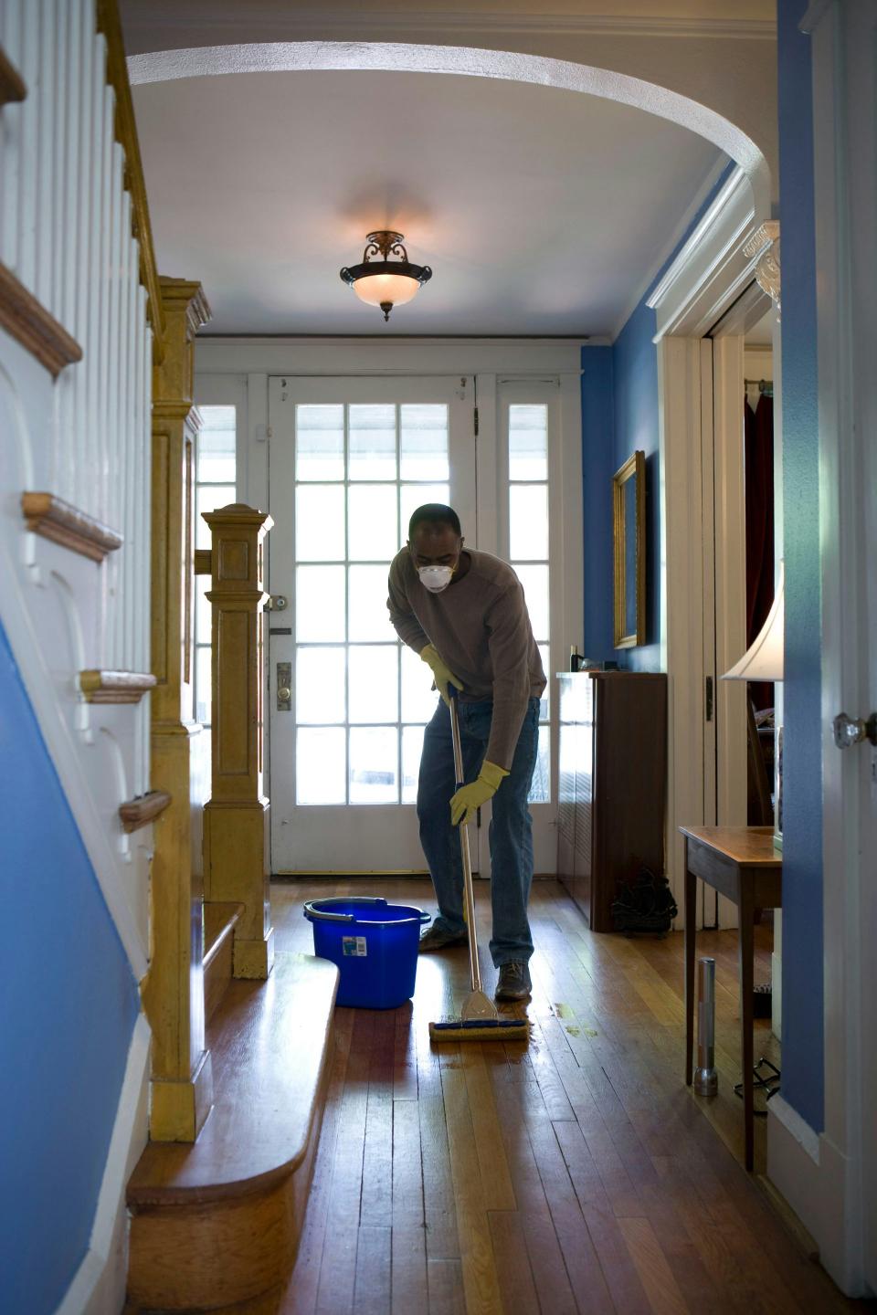 Person cleaning wooden floor